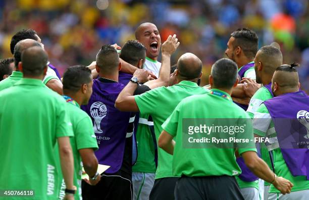 Sofiane Feghouli of Algeria celebrates with team-mates after scoring the team's first goal from the penalty spot during the 2014 FIFA World Cup...