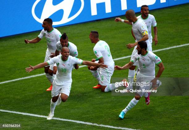 Sofiane Feghouli of Algeria celebrates with his teammates after scoring his team's first goal on a penalty kick during the 2014 FIFA World Cup Brazil...