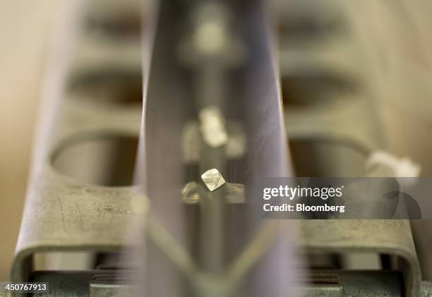 Rough diamonds pass through an automatic sorting machine in the sorting center at OAO Alrosa's Mir diamond mine in Mirny, Russia, on Thursday, Nov....