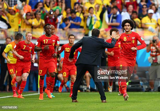 Marouane Fellaini of Belgium celebrates scoring his team's first goal with head coach Marc Wilmots during the 2014 FIFA World Cup Brazil Group H...