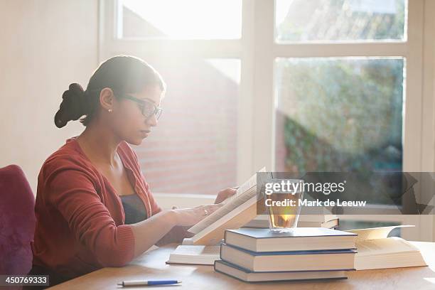 netherlands, goirle, young woman studying books at desk - self development stock pictures, royalty-free photos & images