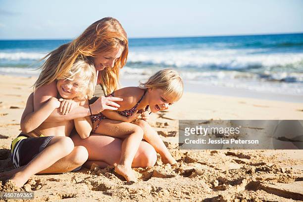 mother with son (6-7) and daughter (2-3) on beach - familia en la playa fotografías e imágenes de stock