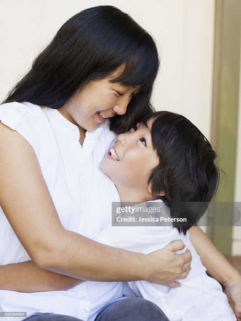 Boy (8-9) embracing mother