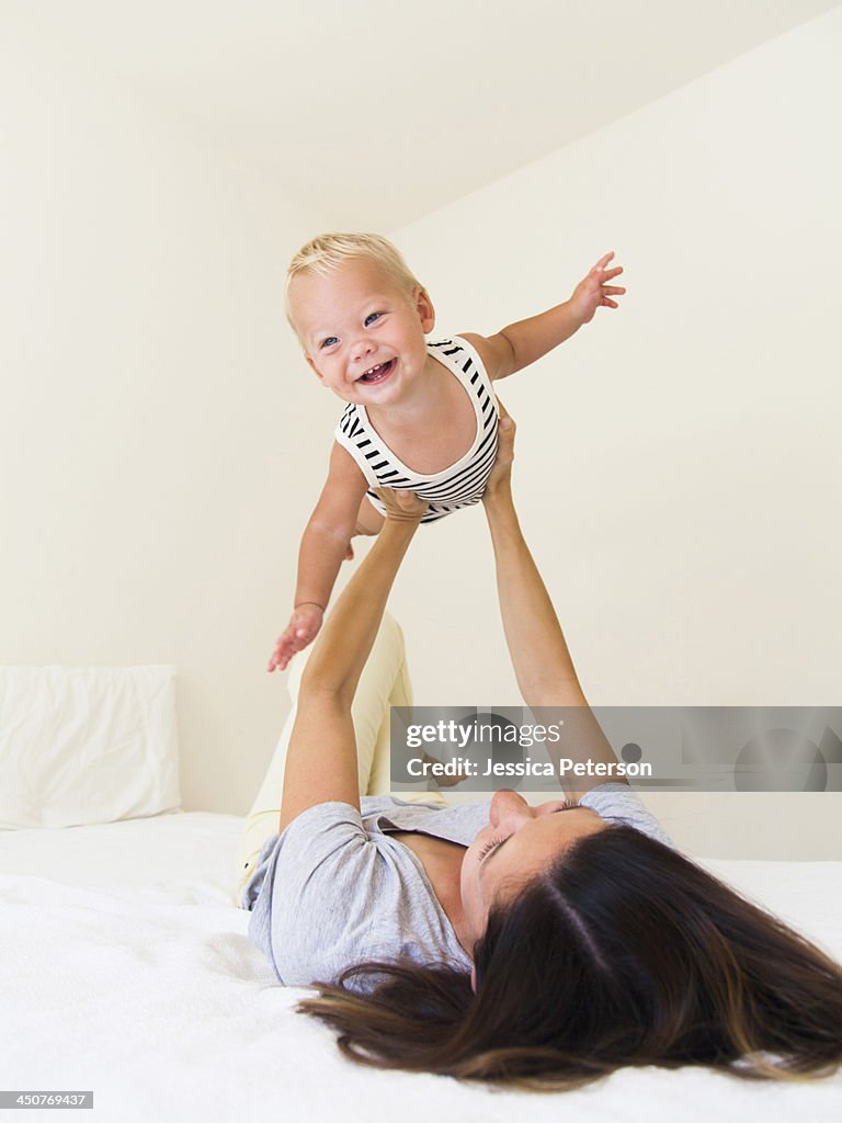 Mother playing with baby boy (6-11 months)