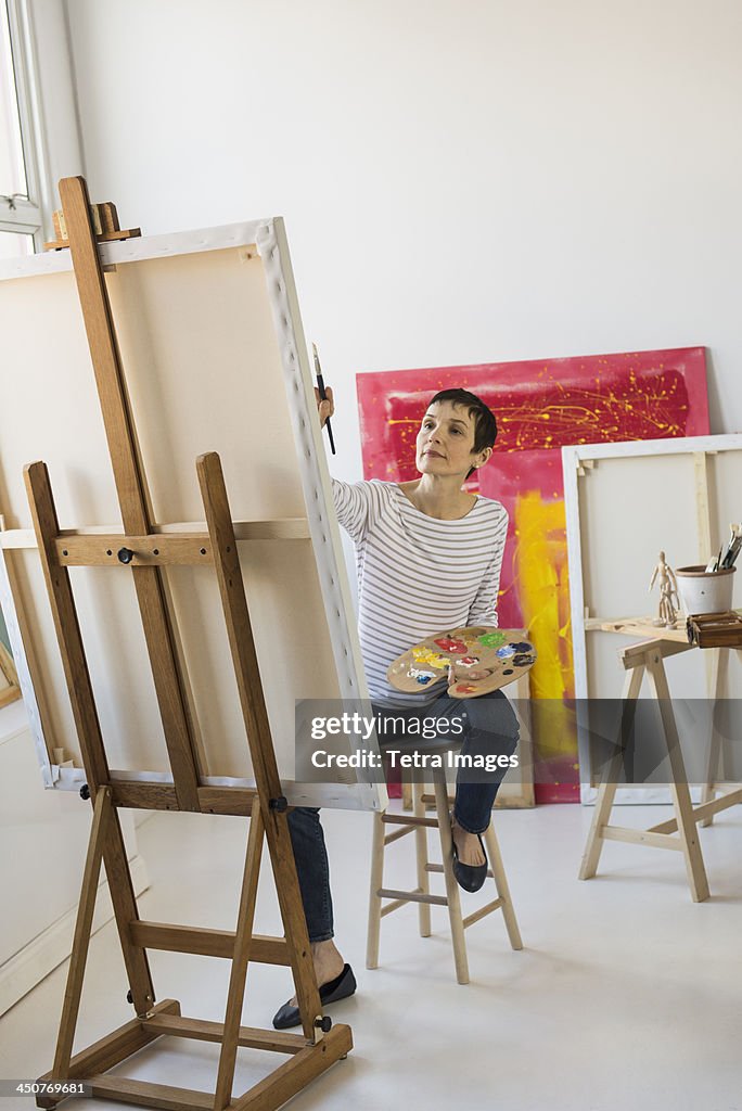 Female artist painting in her studio