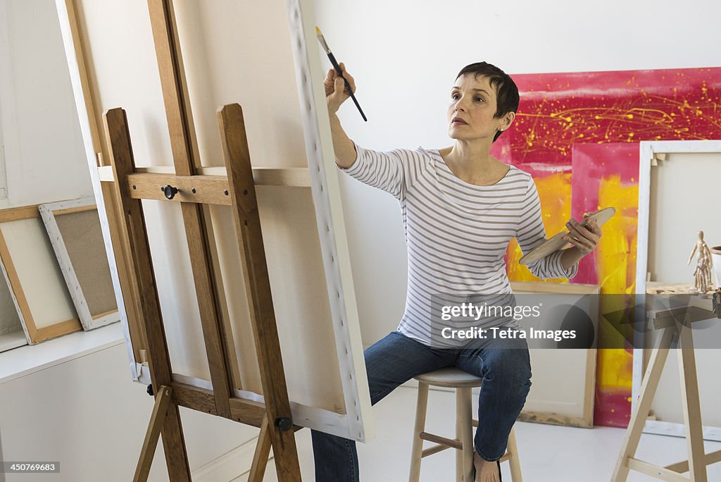 Female artist painting in her studio
