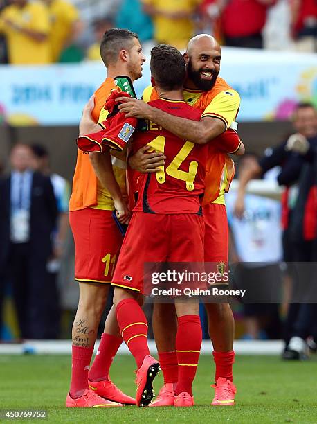 Dries Mertens of Belgium celebrates with teammate Kevin Mirallas and Anthony Vanden Borre after defeating Algeria 2-1 during the 2014 FIFA World Cup...