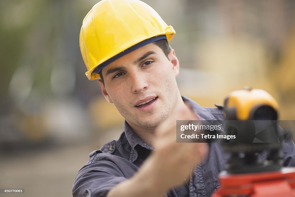 Engineer using theodolite