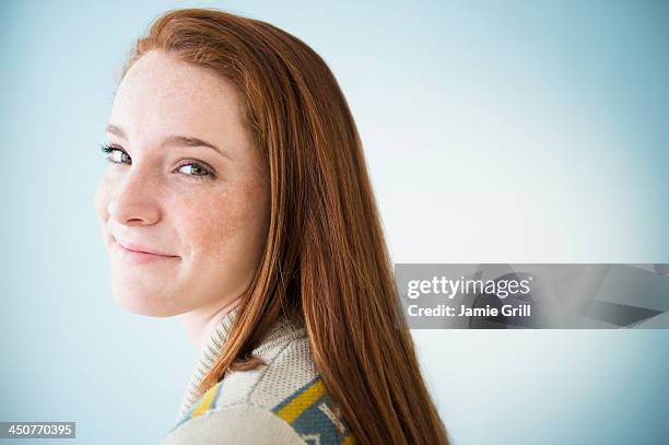 portrait of smiling teenage girl (14-15), studio shot - freckle girl stock pictures, royalty-free photos & images