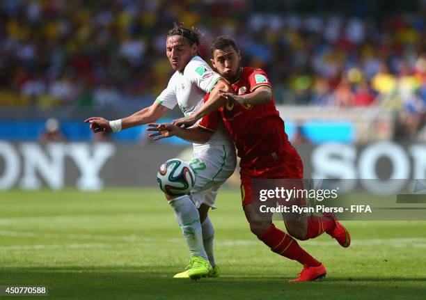 Mehdi Mostefa of Algeria challenges Eden Hazard of Belgium for the ball during the 2014 FIFA World Cup Brazil Group H match between Belgium and...