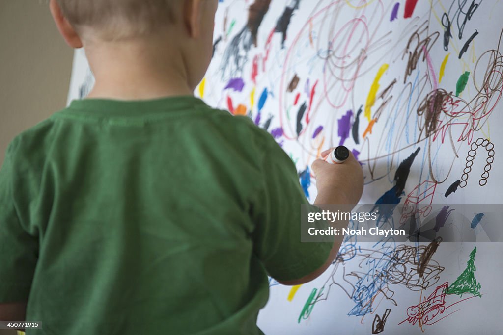 USA, Montana, Whitefish, Toddler drawing on wall