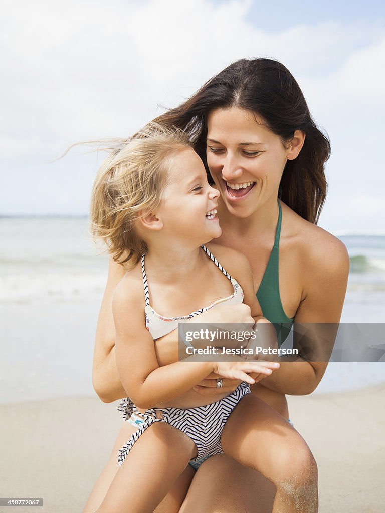 Mother with daughter (2-3) on beach