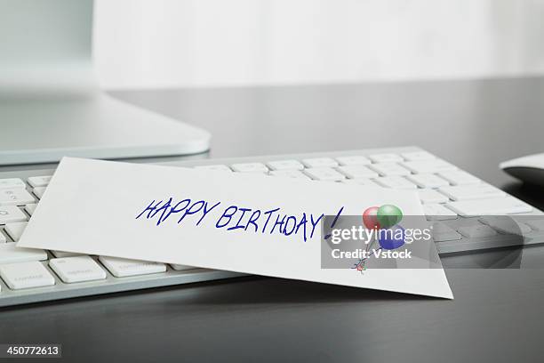 close-up of birthday card on keyboard - birthday card stock pictures, royalty-free photos & images