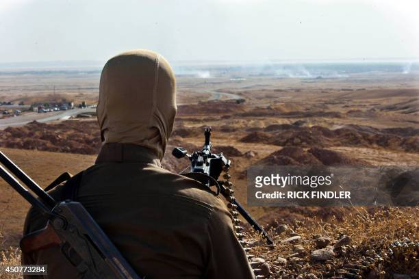 Member of Kurdish Peshmerga forces takes position overlooking militants of the Islamic State of Iraq and the Levant positions in Jalawla in the...