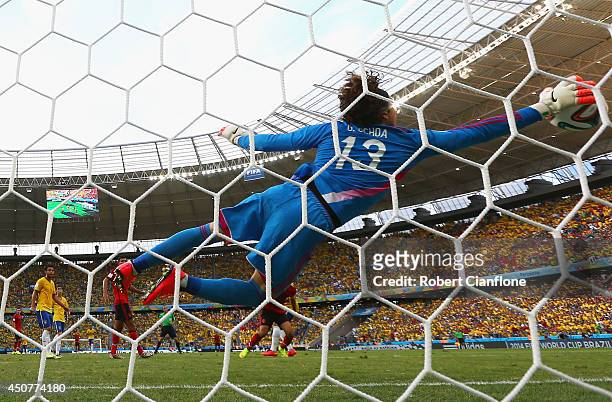 Guillermo Ochoa of Mexico dives to make a save during the 2014 FIFA World Cup Brazil Group A match between Brazil and Mexico at Castelao on June 17,...
