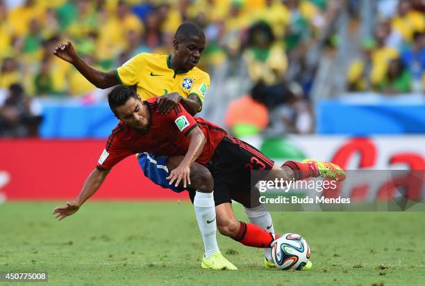 Ramires of Brazil and Jose Juan Vazquez of Mexico collide during the 2014 FIFA World Cup Brazil Group A match between Brazil and Mexico at Castelao...