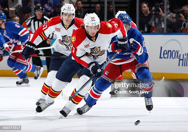 Tom Gilbert of the Florida Panthers skates for the puck against the New York Rangers at Madison Square Garden on November 10, 2013 in New York City....
