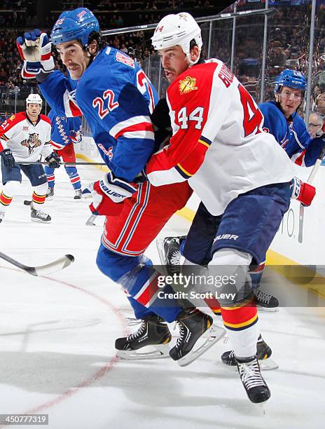 Brian Boyle of the New York Rangers and Erik Gudbranson of the Florida Panthers skate for the puck at Madison Square Garden on November 10, 2013 in...