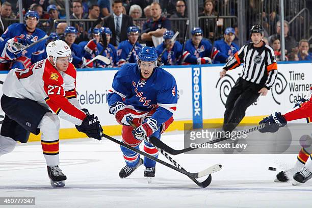 Michael Del Zotto of the New York Rangers skates the puck up the ice against the Florida Panthers at Madison Square Garden on November 10, 2013 in...