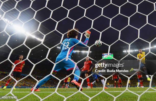 Guillermo Ochoa of Mexico makes a save after a header by Thiago Silva of Brazil during the 2014 FIFA World Cup Brazil Group A match between Brazil...