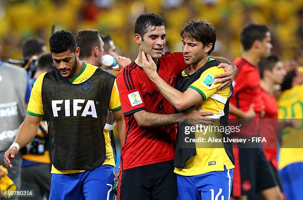 Rafael Marquez of Mexico and Maxwell of Brazil hug each other after the 2014 FIFA World Cup Brazil Group A match between Brazil and Mexico at Estadio...