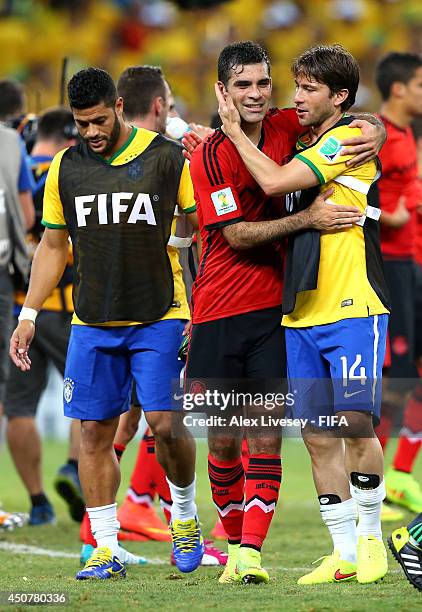 Rafael Marquez of Mexico and Maxwell of Brazil hug each other after the 2014 FIFA World Cup Brazil Group A match between Brazil and Mexico at Estadio...