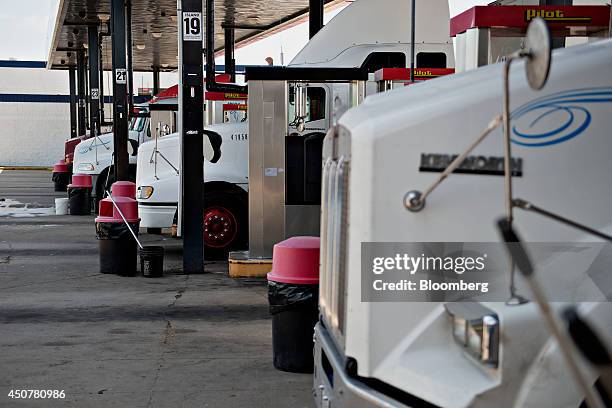 Tractor trailers sit at the fueling pumps of a Road Ranger gas station in Princeton, Illinois, U.S., on Tuesday, June 17, 2014. Gasoline in the U.S....