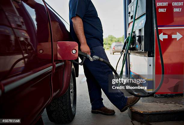 Customer fuels his vehicle at a Road Ranger gas station in Princeton, Illinois, U.S., on Tuesday, June 17, 2014. Gasoline in the U.S. Climbed this...