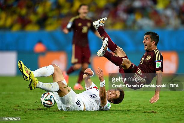 Ki Sung-Yueng of South Korea and Alexander Samedov of Russia clash during the 2014 FIFA World Cup Brazil Group H match between Russia and Korea...