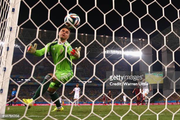 Igor Akinfeev of Russia fails to save a shot by Lee Keun-Ho of South Korea for South Korea's first goal during the 2014 FIFA World Cup Brazil Group H...