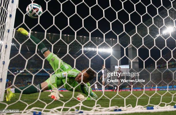 Igor Akinfeev of Russia fails to save a shot by Lee Keun-Ho of South Korea for South Korea's first goal during the 2014 FIFA World Cup Brazil Group H...