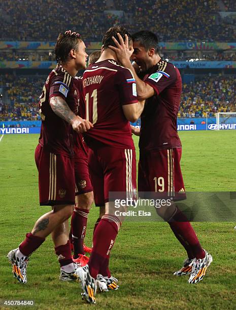 Aleksandr Kerzhakov of Russia celebrates with teammates Andrey Yeshchenko and Alexander Samedov after scoring his team's first goal during the 2014...