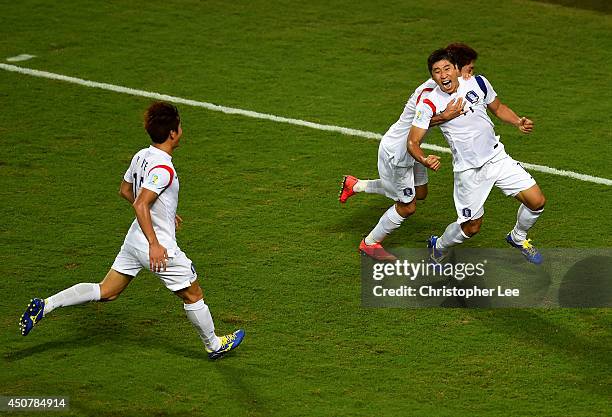 Lee Keun-Ho of South Korea celebrates scoring his team's first goal with Lee Chung-Yong and Lee Yong during the 2014 FIFA World Cup Brazil Group H...