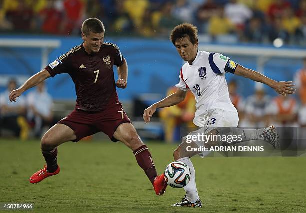 Russia's midfielder Igor Denisov and South Korea's forward Koo Ja-Cheol vie during the Group H football match between Russia and South Korea in the...