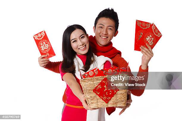 young couple celebrating chinese new year - gift hamper stock pictures, royalty-free photos & images