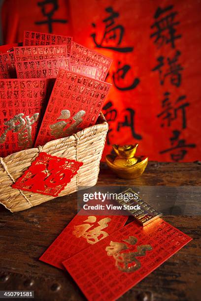 close-up of gold ingots and red envelopes - gift baskets stock pictures, royalty-free photos & images