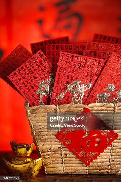 close-up of gold ingots and red envelopes - gift baskets stock pictures, royalty-free photos & images