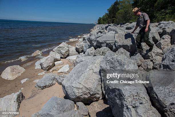 Bruce Rowe, park ranger with the National Park Service, walks down on a riprap built to prevent beach erosion at the Indiana Dunes National Lakeshore...