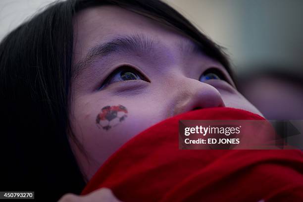 Woman watches a K-Pop concert prior to a public screening in Seoul of the South Korea vs Russia football match at the 2014 World Cup in Brazil, early...