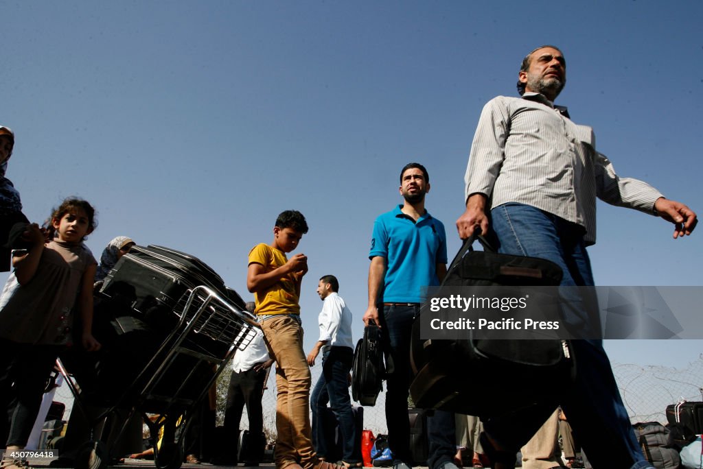 Palestinians wait to cross into Egypt at the Rafah border...