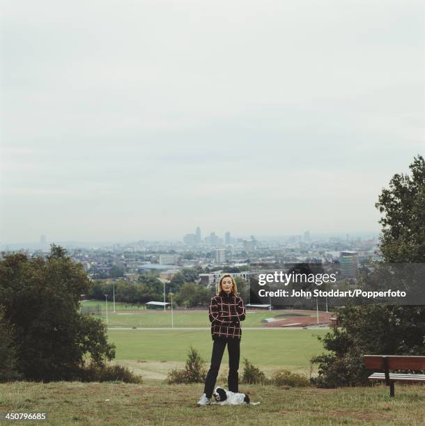 English film and television actress Amanda Donohoe with her dog on Parliament Hill, London, circa 1995.