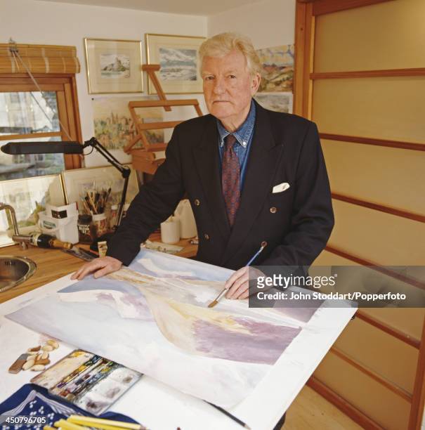 English journalist, historian, speechwriter and author Paul Johnson shows his watercolour landscape painting, circa 1995.
