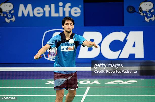 Parupalli Kashyap of India returns a shot against Kenichi Tago of Japan during the BCA Indonesia Open 2014 MetLife BWF World Super Series Premier at...