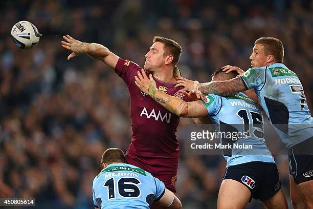 Brent Tate of the Maroons offloads the ball during game two of the State of Origin series between the New South Wales Blues and the Queensland...