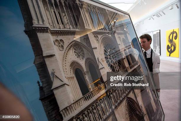 Art handlers carry Thomas Struth's 2000 piece Notre Dame, Paris, at Sotheby's auction house on June 18, 2014 in London, England. The Sotheby's...