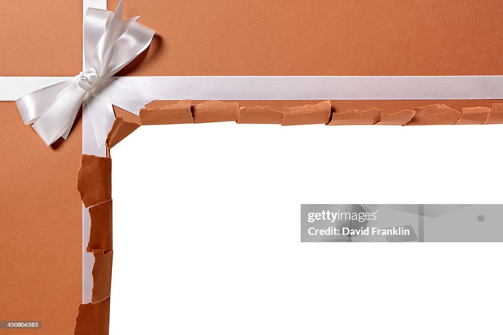 Torn package with gift ribbon