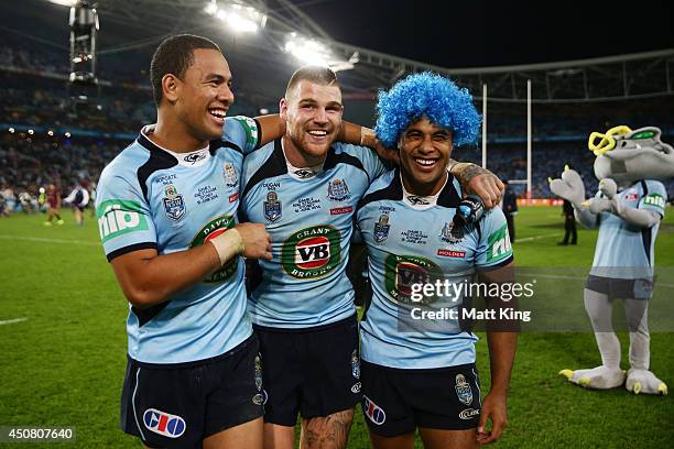 Will Hopoate, Josh Dugan and Michael Jennings of the Blues celebrate the series victory at the end of game two of the State of Origin series between...