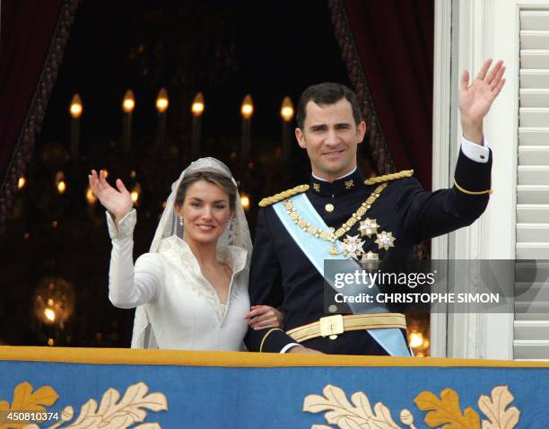 Princess of Asturias Letizia Ortiz and her husband Spanish Crown Prince Felipe of Bourbon wave to the crowd after their their wedding ceremony 22 May...