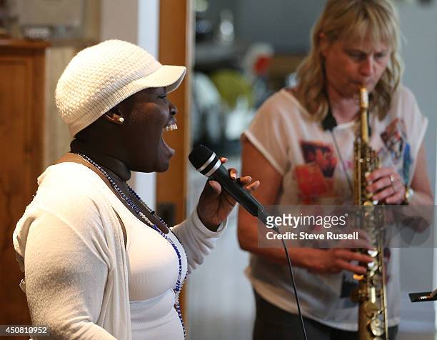 Dayme Arocena sings vocals as Saxophone player Jane Bunnett and her all-girl Cuban band rehearse for their upcoming tour and appearance at the TD...