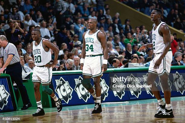 Sherman Douglas, Xavier McDaniel, and Dominique Wilkins of the Boston Celtics stand on the court during a game played in 1995 against the Orlando...